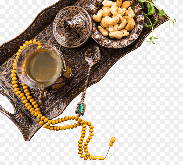 Tea glass with nuts and beads on tray PNG